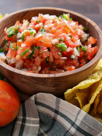 Authentic bowl of pico de gallo with a side serving of chips