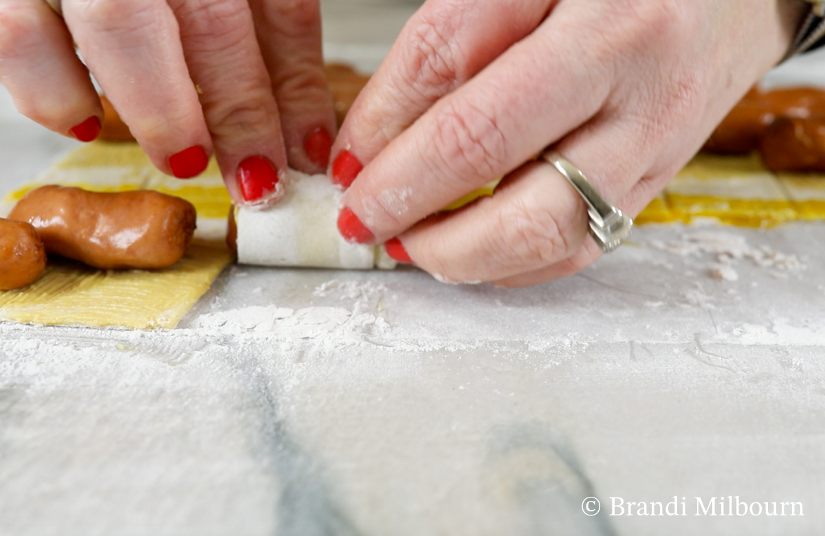 Place lit'l smokies on pastry puff and roll up starting with mustard end, then ending with yolk to seal. Press dough to seal if needed.