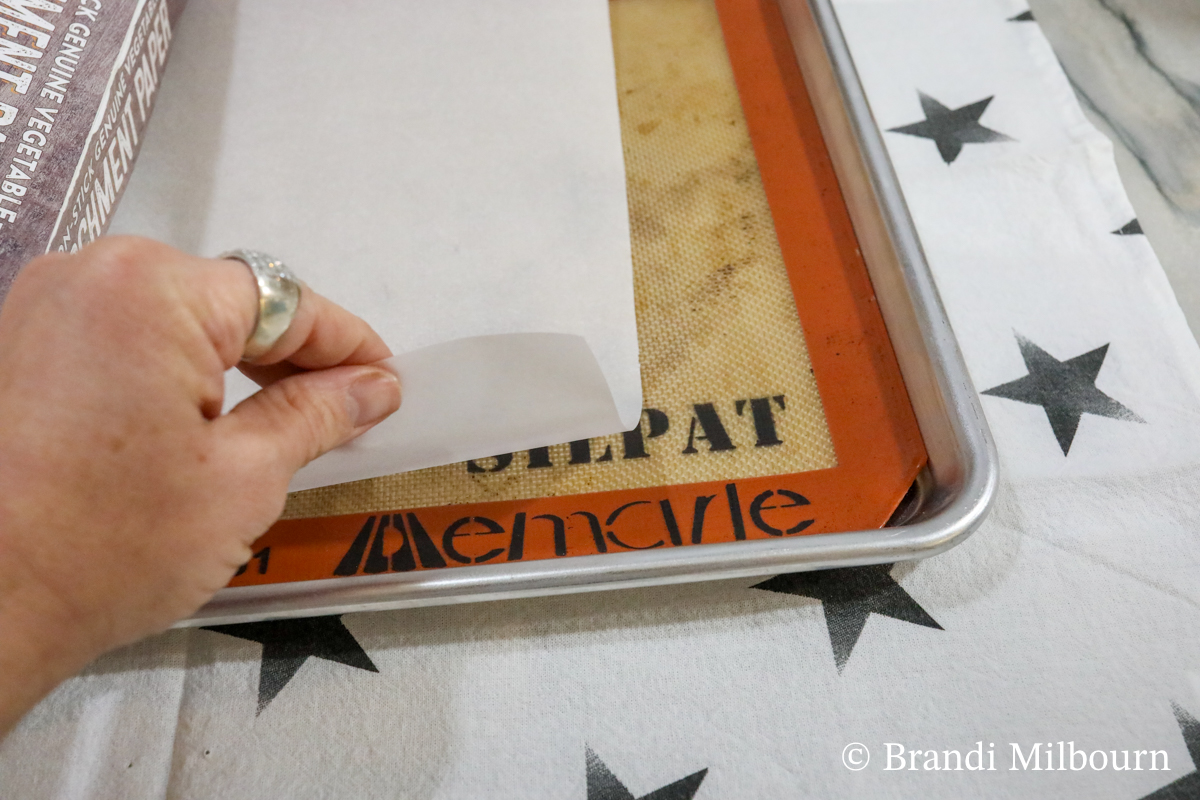 baking sheet lined with silat or silicone mat then covered with parchment paper.