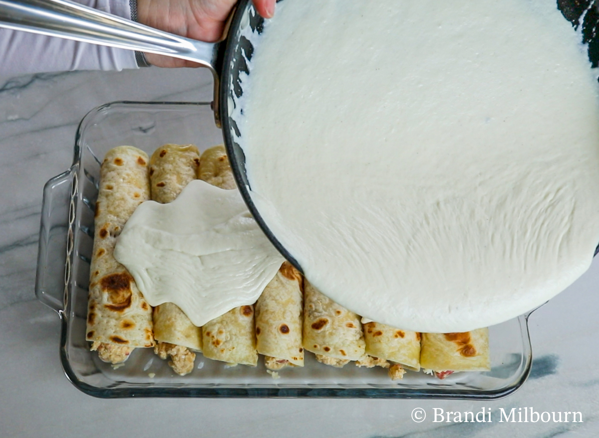 Cover tortillas with sour cream sauce.