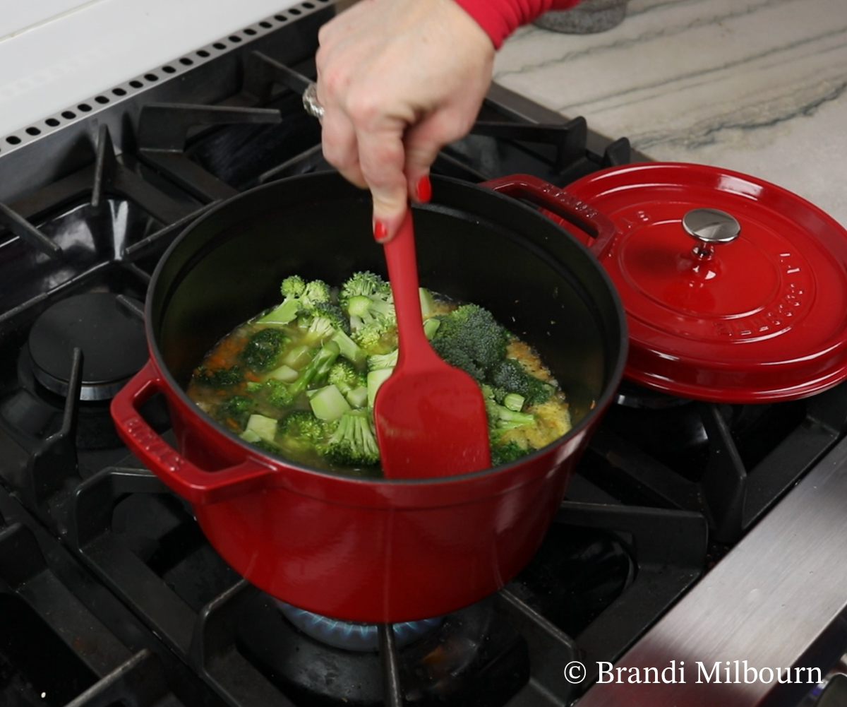 Broccoli cheese soup adding broccoli to the stock pot