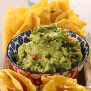 Bowl of guacamole surrounded by chips