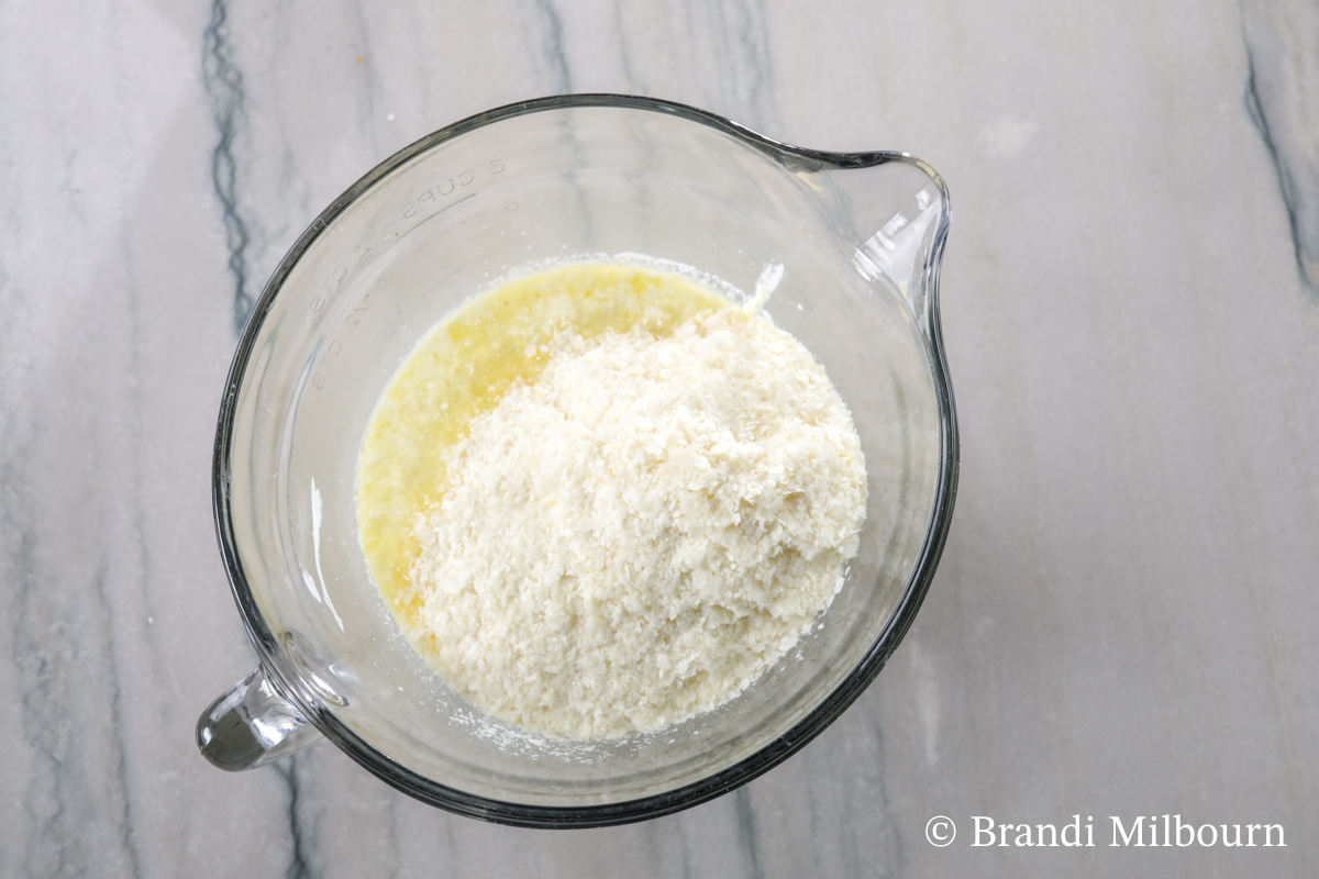 Adding instant mashed potatoes to chicken broth, butter, sour cream, heavy cream, milk