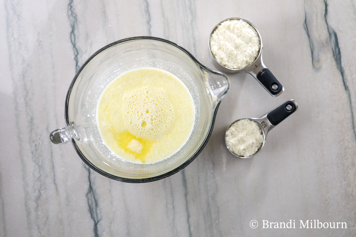 Preparing ingredients for instant potatoes that are Heated for five minutes chicken broth, butter, sour cream, heavy cream, milk and pepper in Microwavable bowl