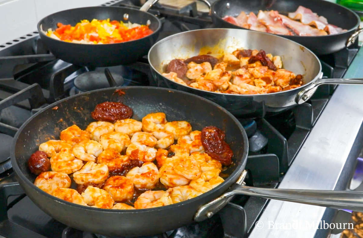 Cook shrimp, chicken, bacon in skillets