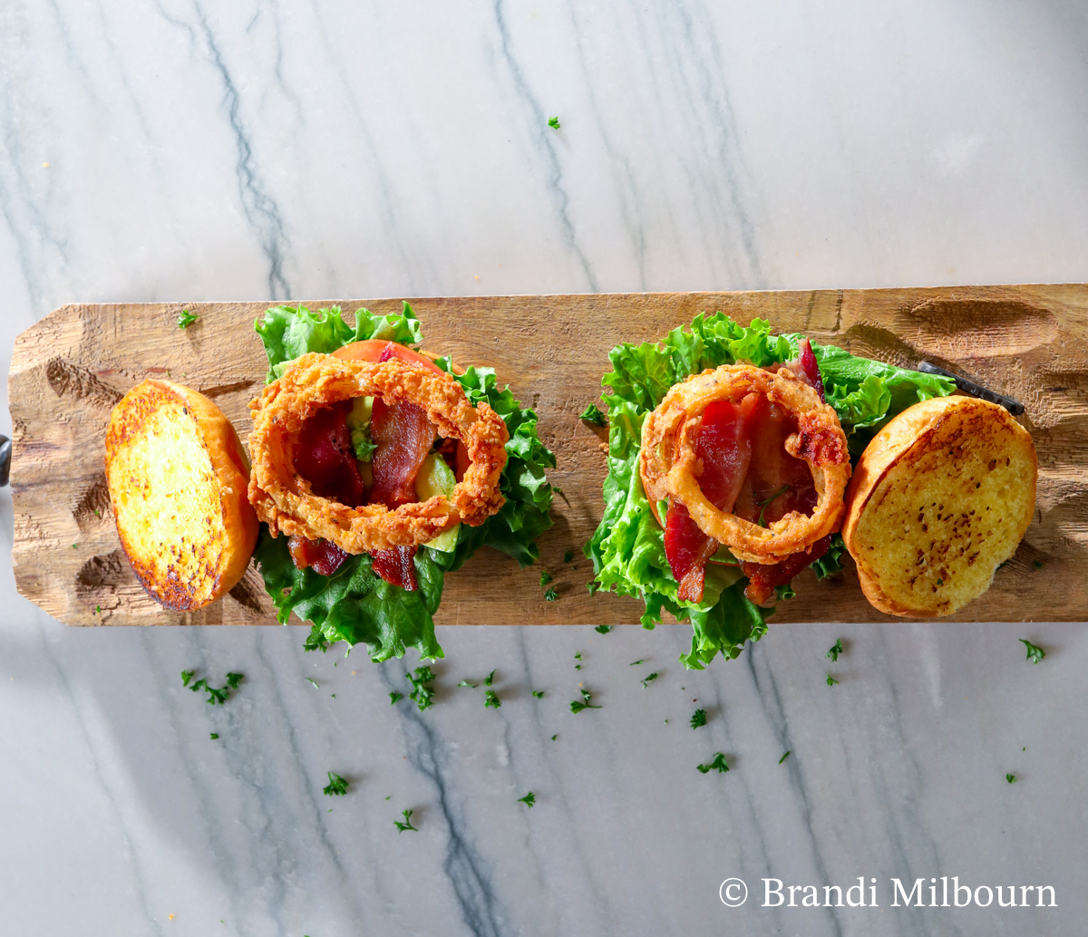 Prep Toasted buns with lettuce tomato, onus ring and bacon.